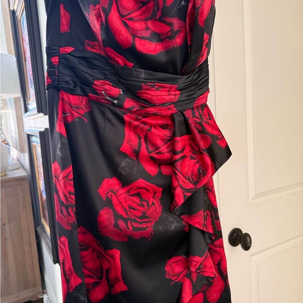 White House Black Market Asymmetrical black Dress with Red Floral Design.